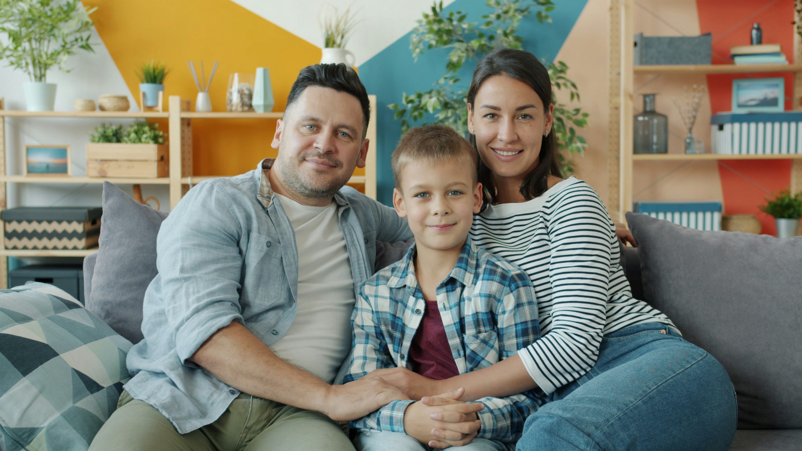 family resting on a clean and tidy home couch